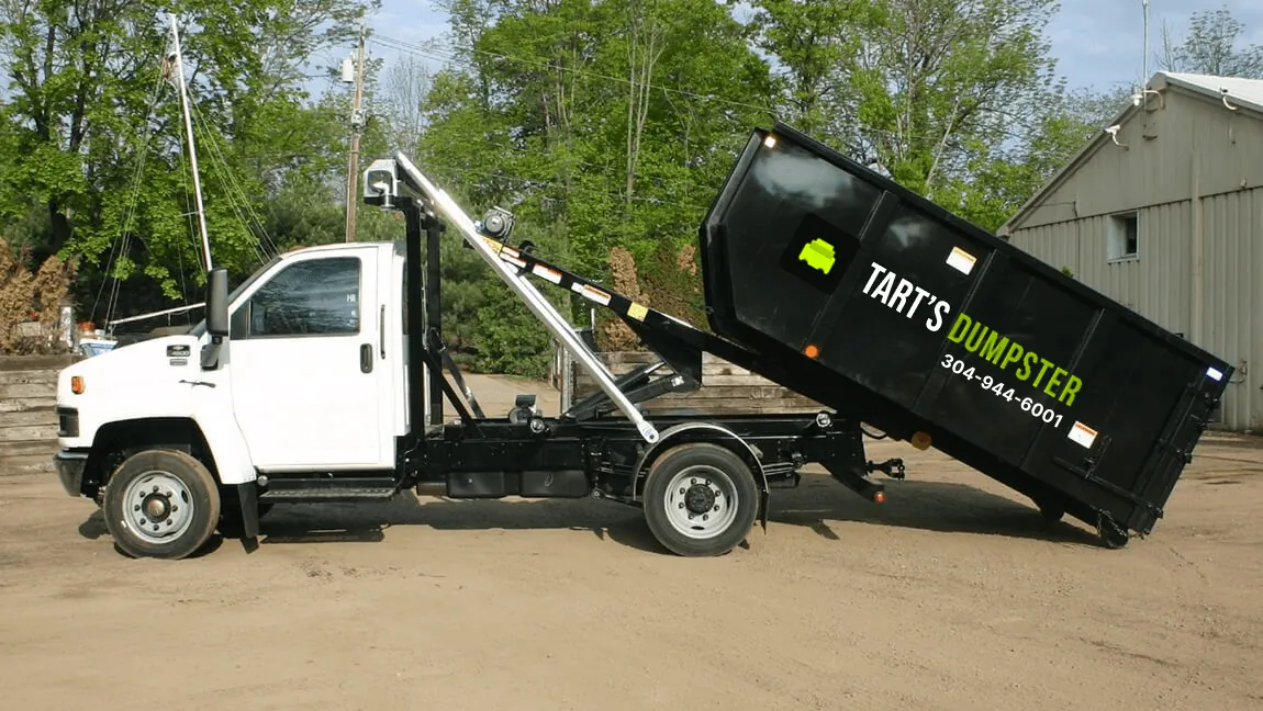 Tart’s truck setting a dumpster down on a job site